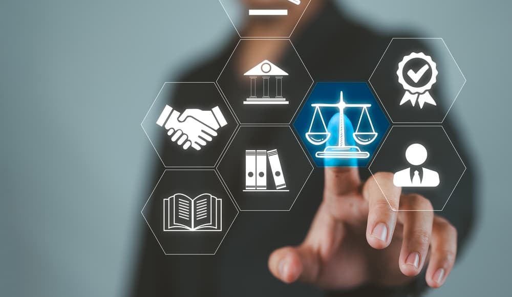 Lawyer providing legal advice on business legislation and computer-related crime, with paperwork and a computer in the background, symbolizing justice and legal expertise.