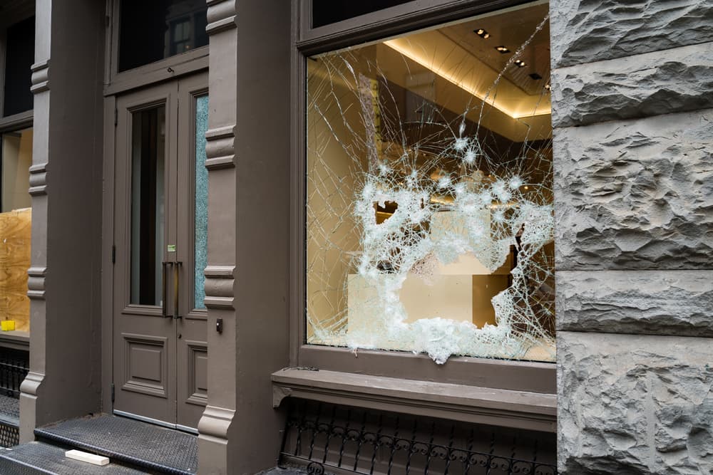 Broken store window by vandals