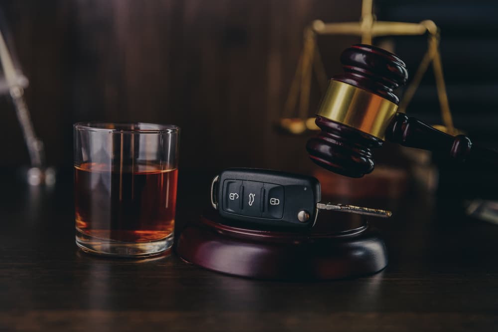 Whiskey with car keys and handcuffs. Concept for drinking and driving